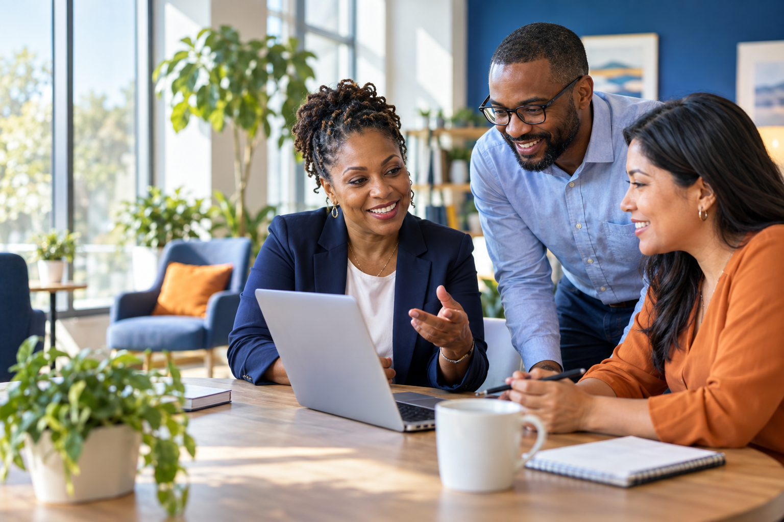 A diverse team collaborating around a laptop